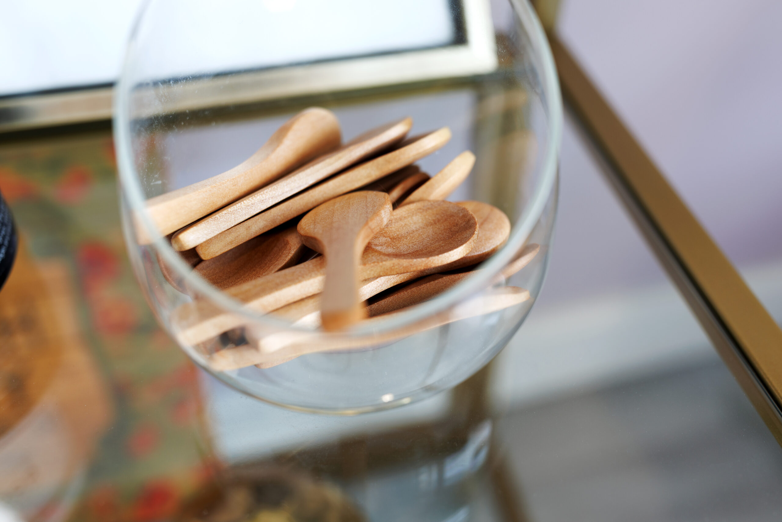 Wooden spatulas in a glass bowl at the studio